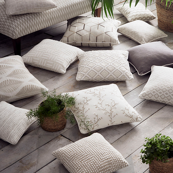 Grey cushions on wooden floorboards